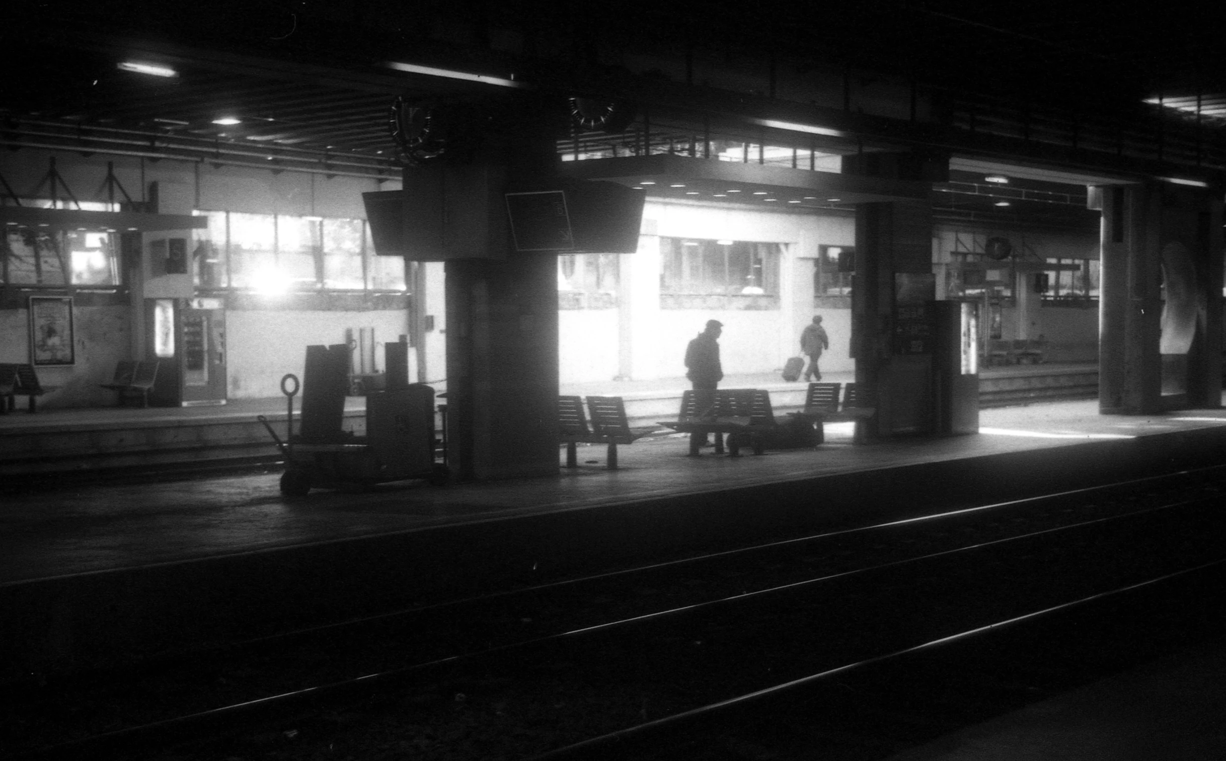 a man is walking on the platform of a train station