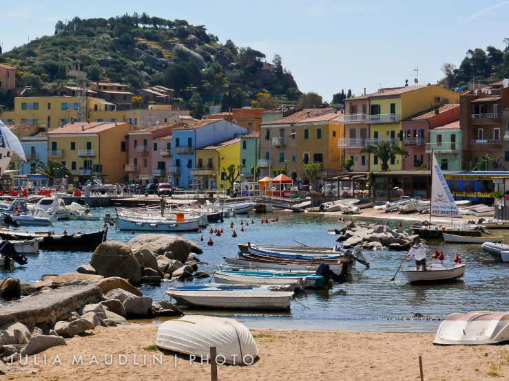 a body of water near several small boats in the water