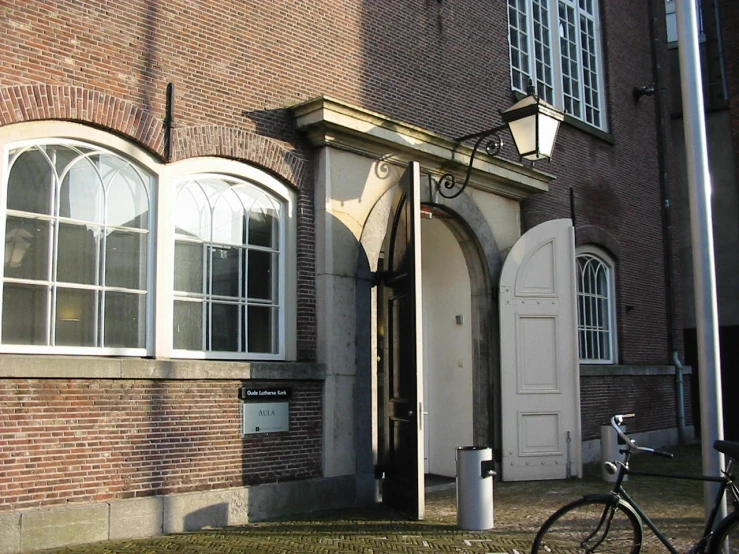 bicycle leaning against a building with arched windows