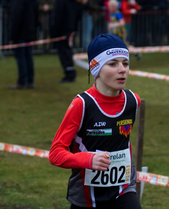 a young person running around a track