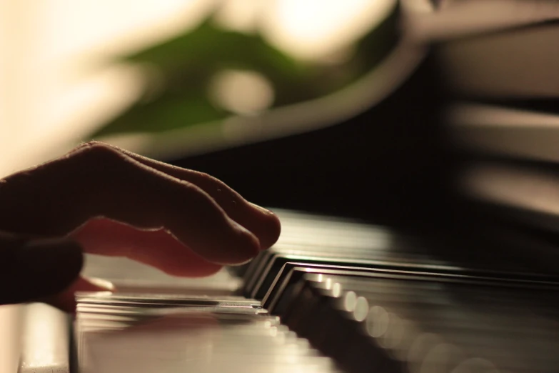 a person playing a piano with their fingers