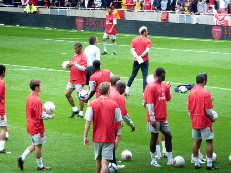 soccer players are on the field near many fans