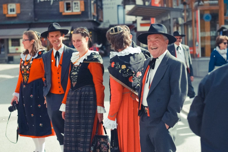 some people in long dresses and hats posing for a picture