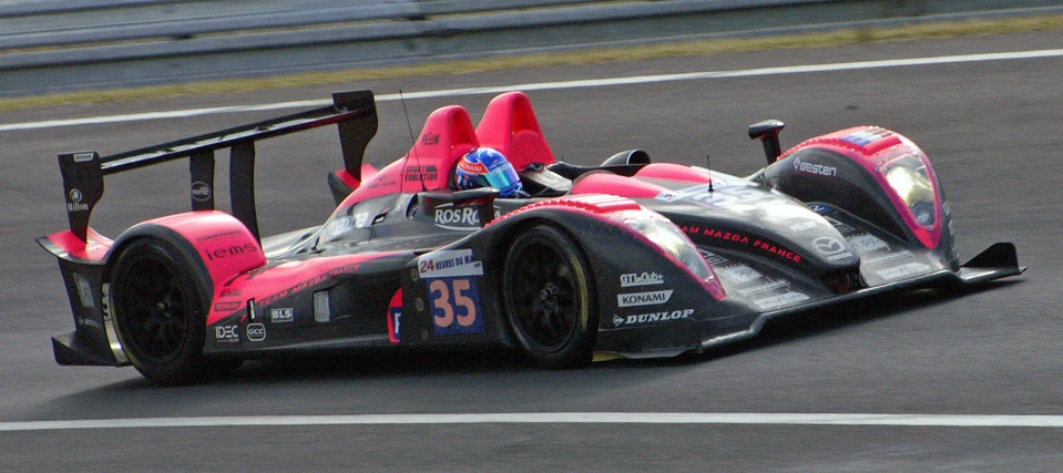 an automobile racing down a track with number 35 on its side