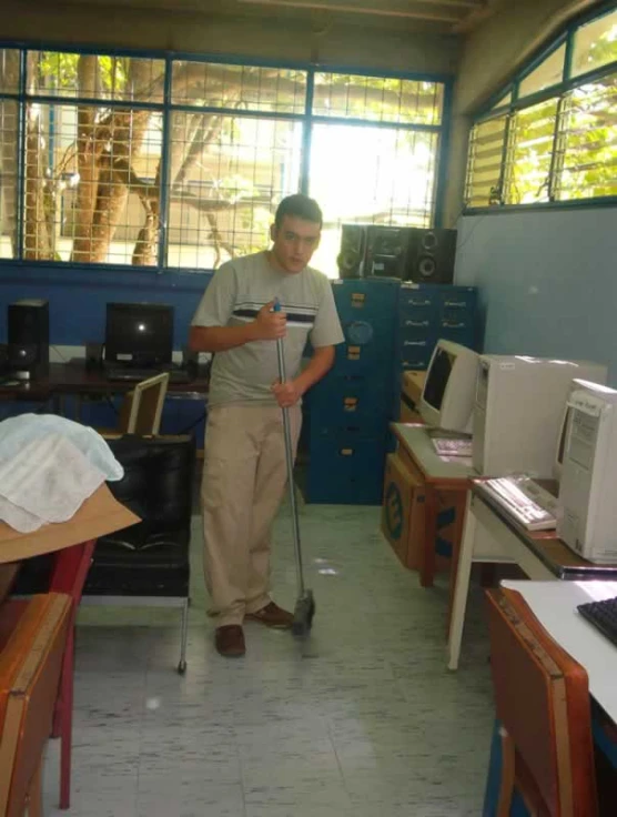 a man standing with a mop and a dust mop