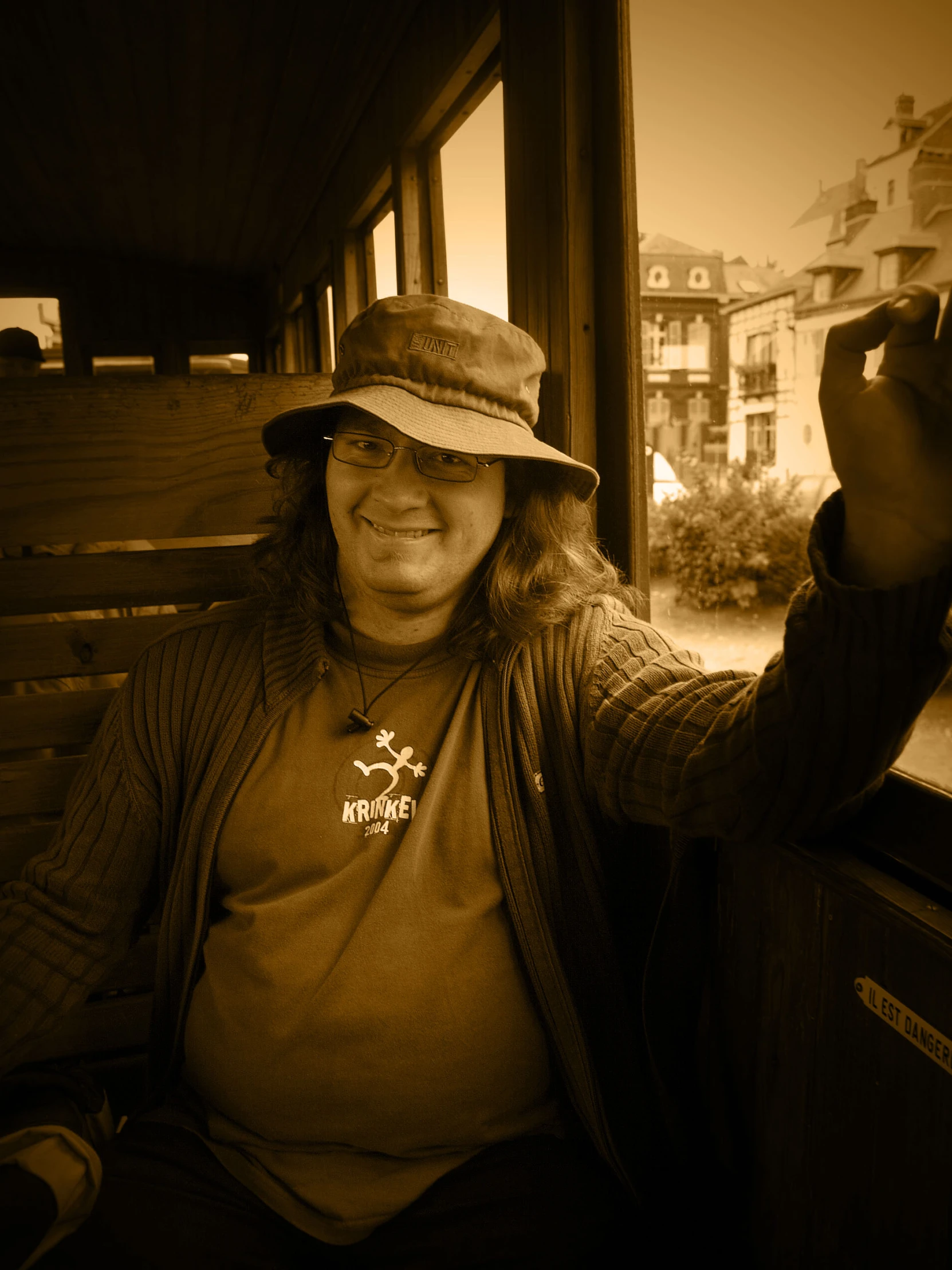 a woman smiling and sitting next to a window