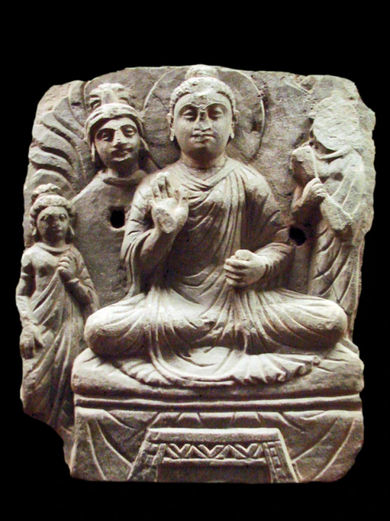 a sculpture with buddha and angels is shown