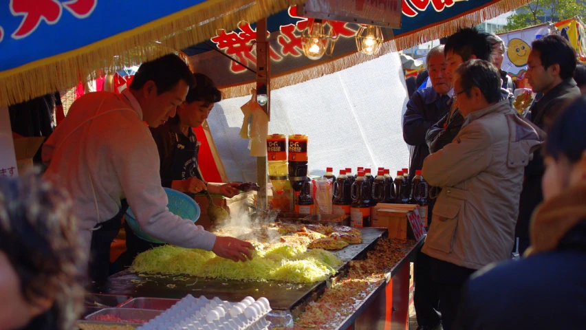 people standing around in an outdoor market area