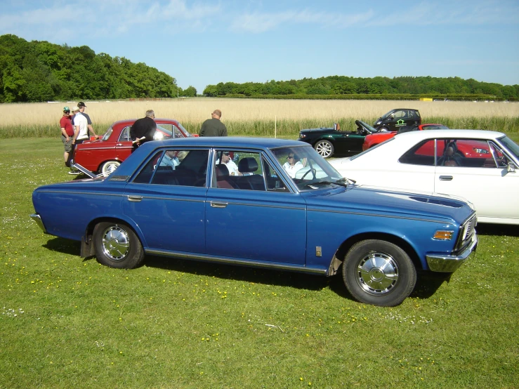 vintage cars in a row at a car show