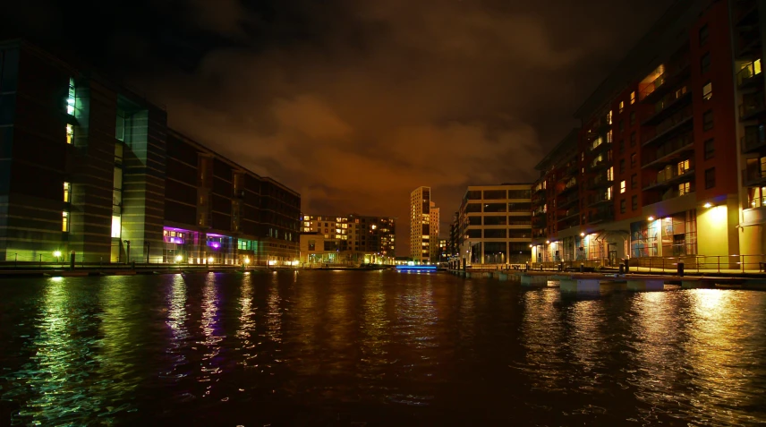 a nighttime view of a river with buildings