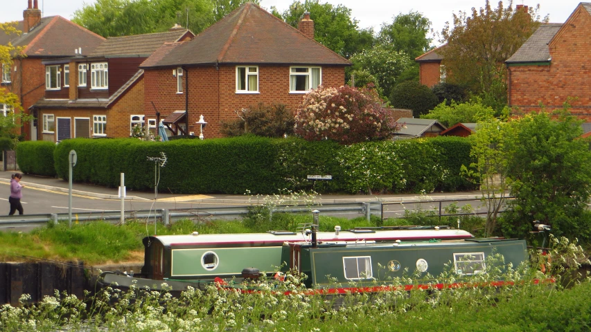 a house next to a canal boat is shown in front of it