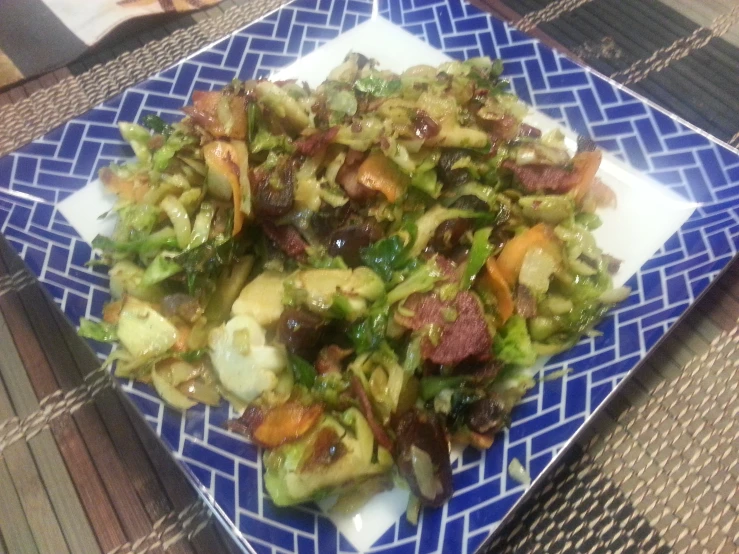 a plate is filled with some vegetables sitting on a table