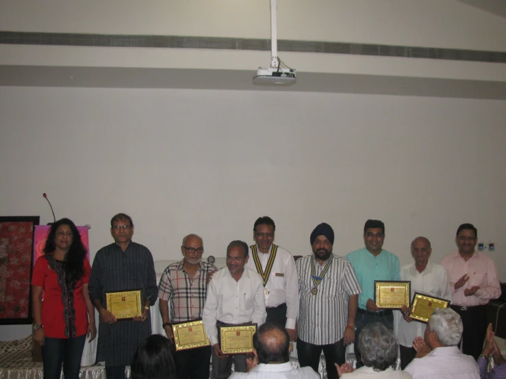 a large group of people with their award plaques