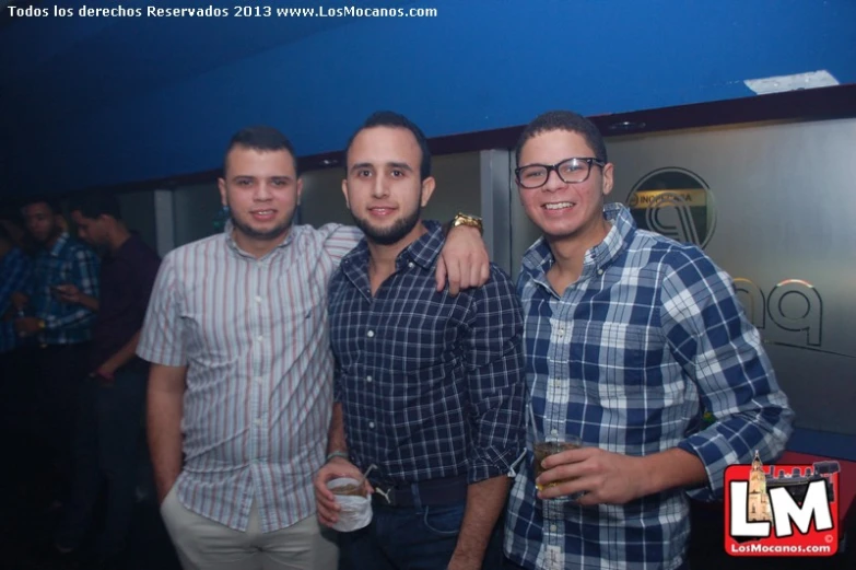 three men posing for the camera in a party