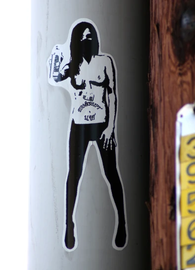 sticker on the side of a pole with an image of a woman and beer