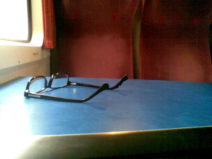 a pair of glasses are sitting on the edge of a table