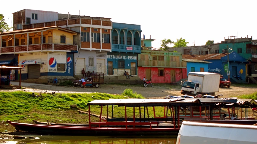 several buildings, some with painted windows, and one with a red boat