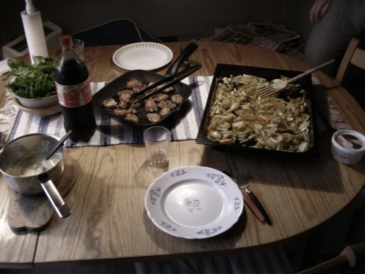 an assortment of food on a table with a wine glass