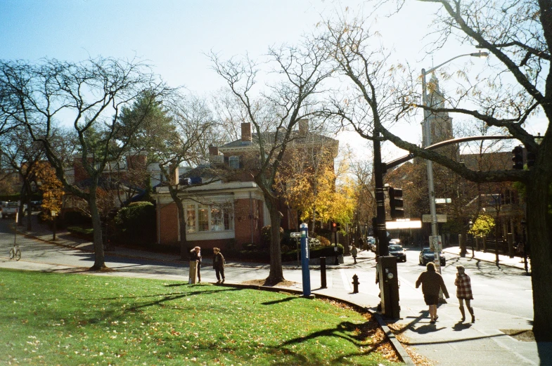 people walking down the sidewalk in a park