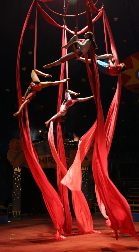 two dancers performing a aerial acrobatic act on stage