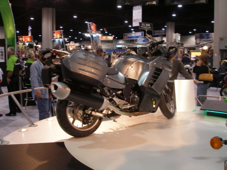 a black motorcycle is on display at a show