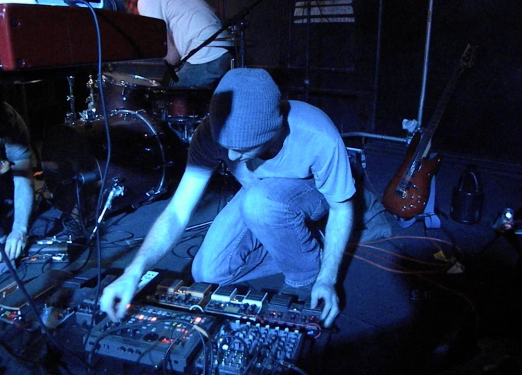 a person in a recording room with some sound equipment