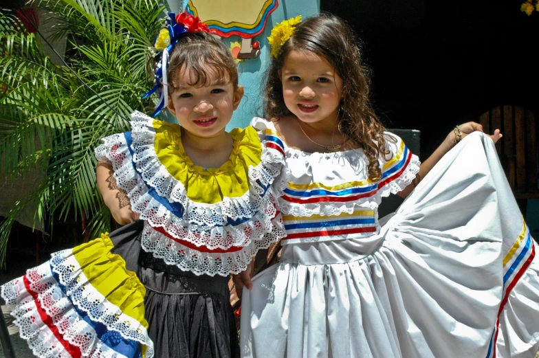 two little girls dressed in dresses that have been made to look like mexican dance dancers