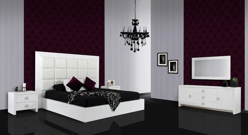an empty bedroom with large white bed and purple accents
