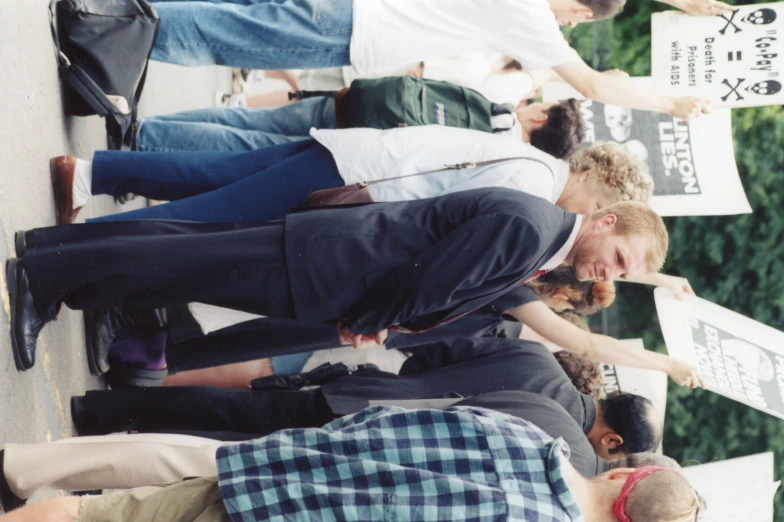 some people standing together and holding signs