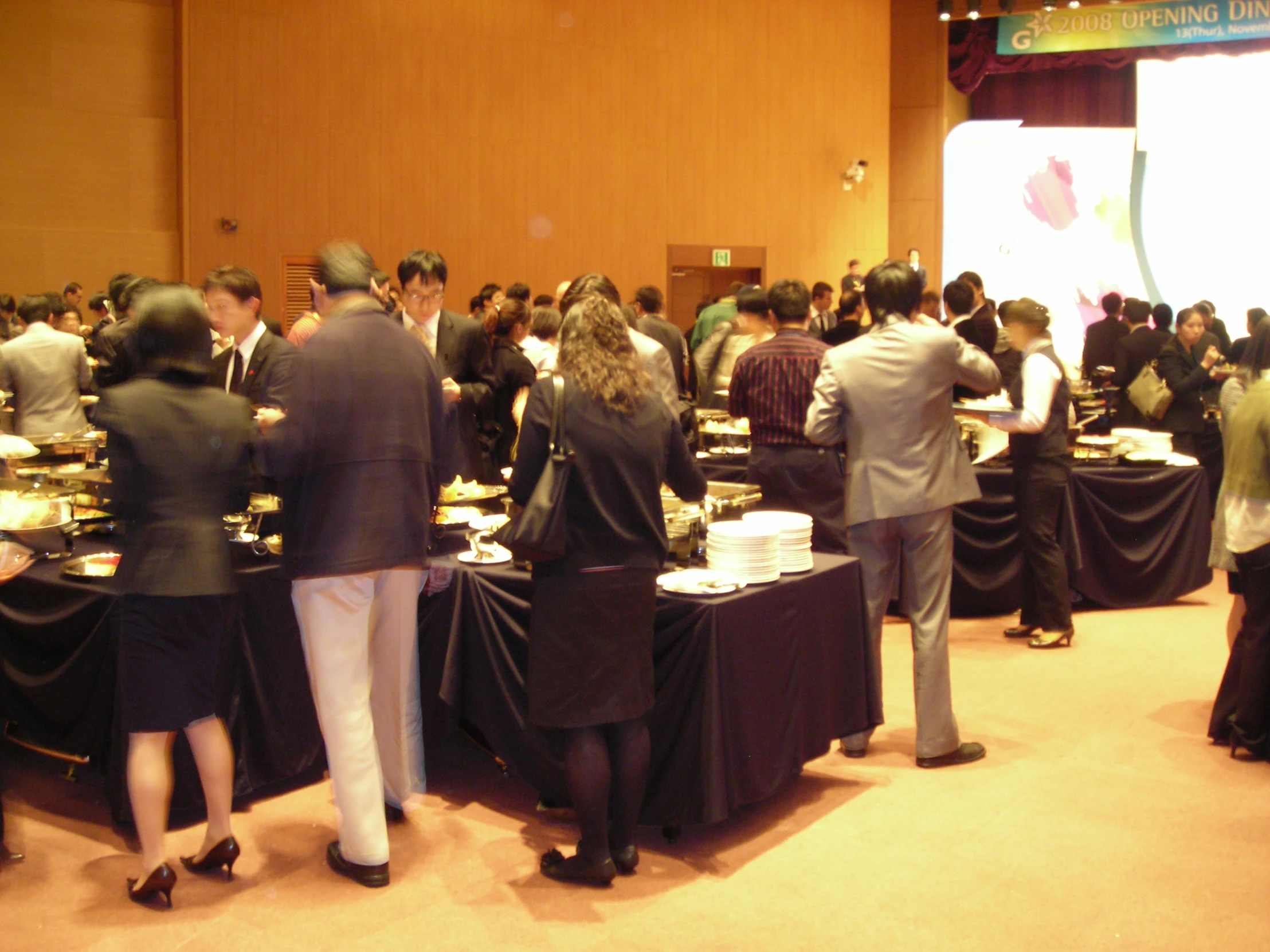 a large group of people standing around tables