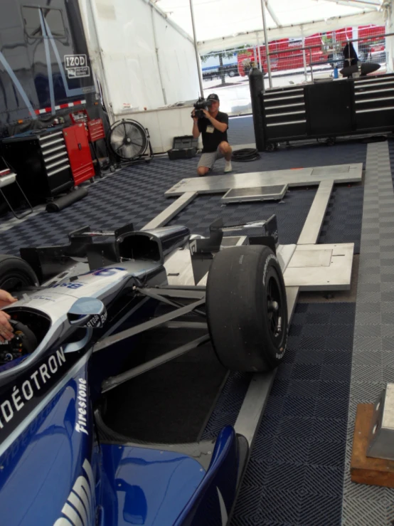 a man sitting on top of a racing car