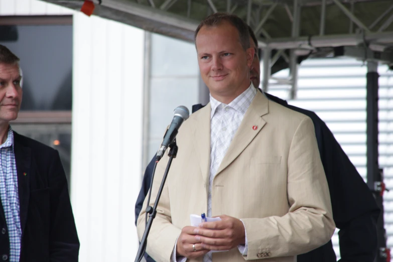 a man in a suit talking into a microphone