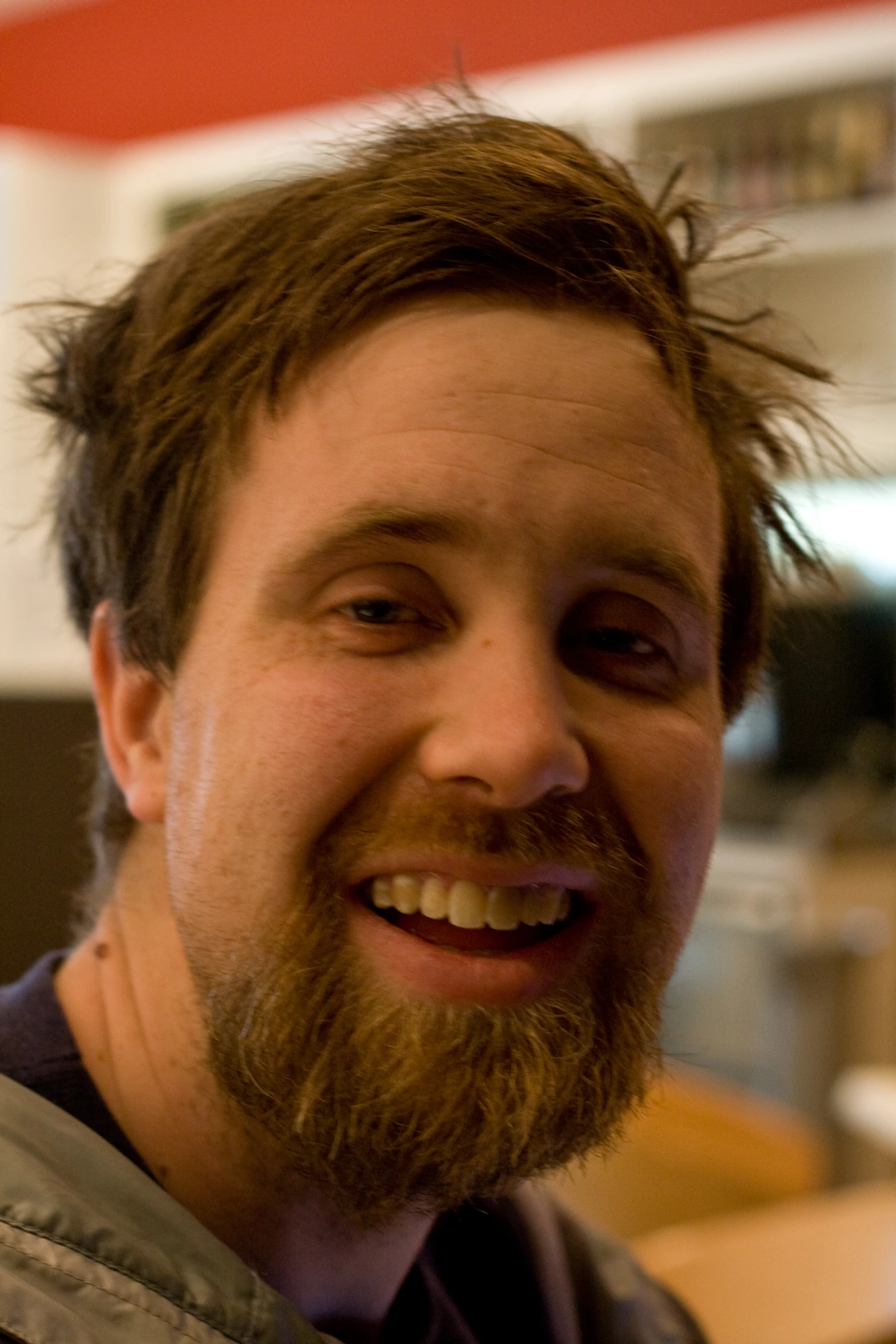 a smiling bearded man with a beard has his mouth open