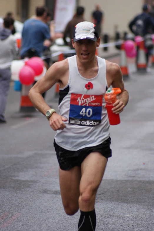 a man wearing a white shirt and shorts running