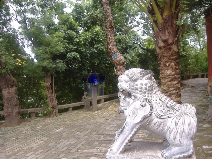 a large stone elephant statue is on a brick floor