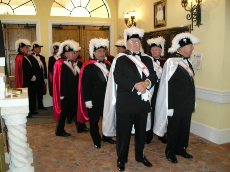 some men in suits and hats are standing together