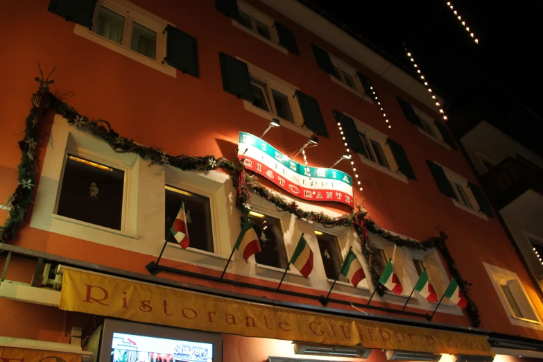 a building decorated for christmas with lights on top