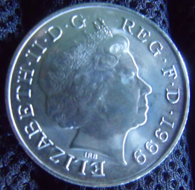 a canadian coin on black knits