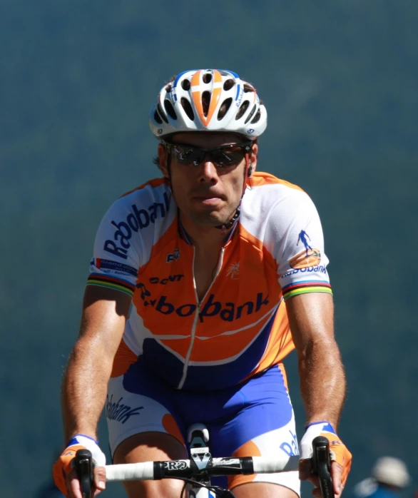 a man on a bike riding in the road