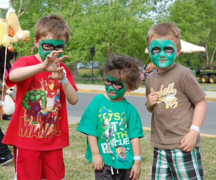 three boys and one girl all have their faces painted like teenage mutant heros