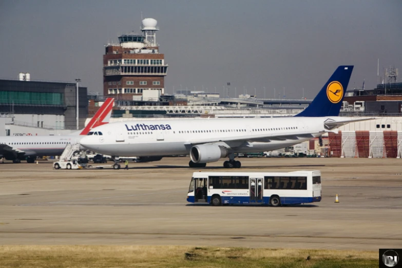 two planes are sitting in an airport with trucks around