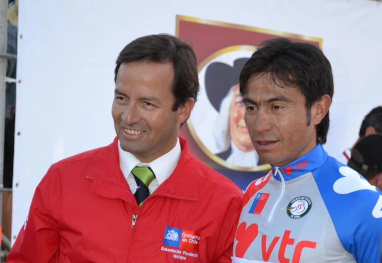 two men wearing cycling wear stand next to each other