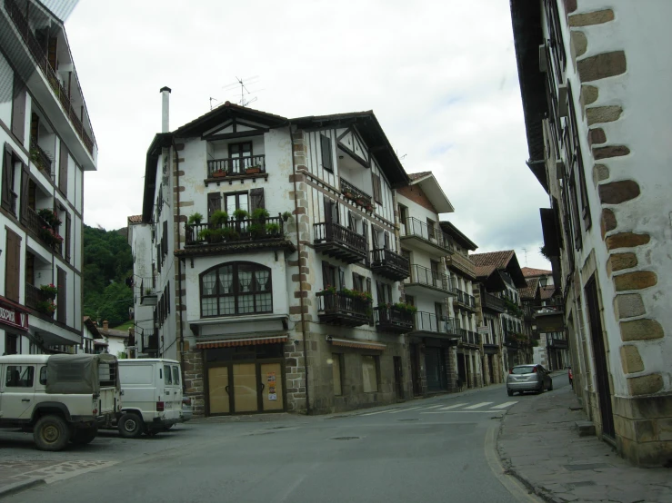 an old european street with a white truck parked on it