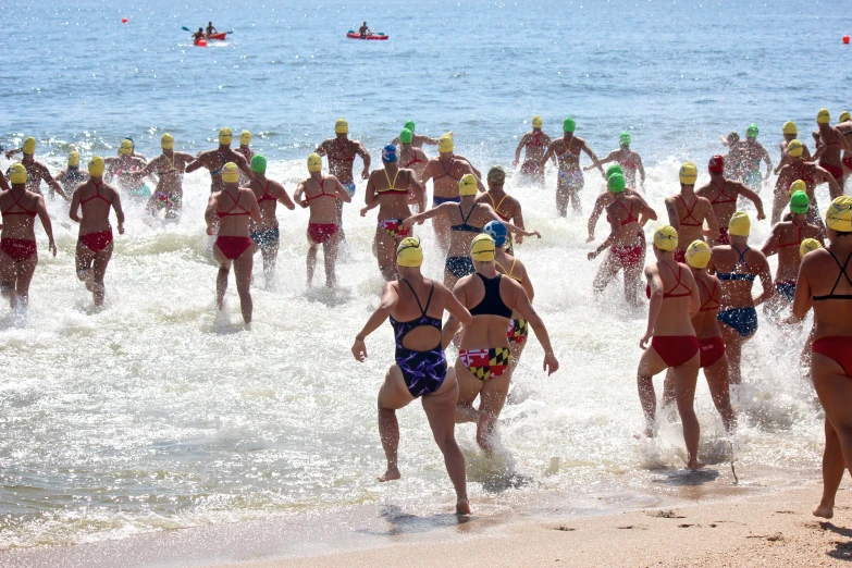 a large group of people standing on top of the ocean