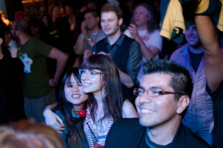 several people are at a party on a crowded dance floor