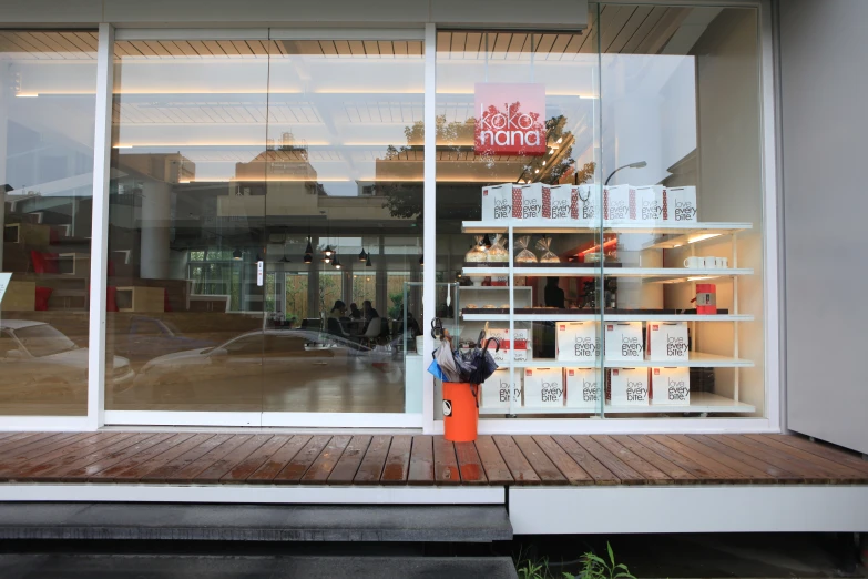 an open glass door of a shop with japanese writing on the shelves