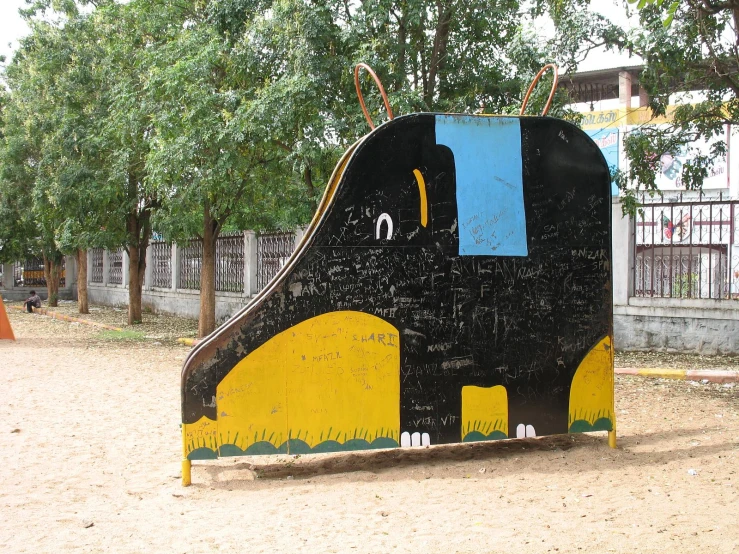 a giant black elephant sculpture in a park