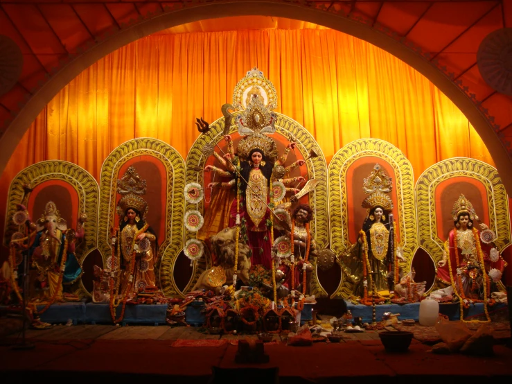 a brightly colored indian temple set up with statues