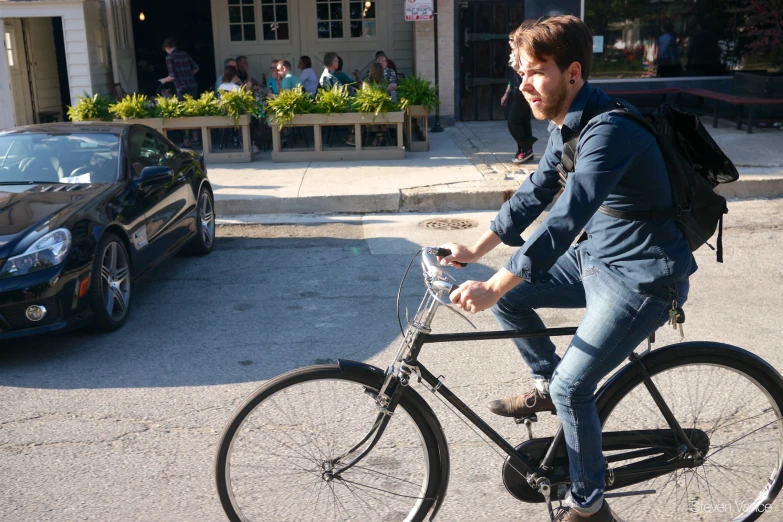 a man riding a bike down the street