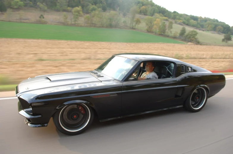 a black car with its hood open and headlights on